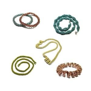 May include: Five beaded necklaces in different colors and styles. The necklaces are made of small beads and are arranged in a circle on a white background.