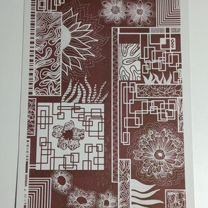 May include: An abstract print in brown and white featuring geometric shapes and floral designs. The print incorporates a range of patterns, including squares, circles, and flowers. The colours are muted and earthy, creating a calming and sophisticated aesthetic.