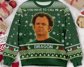 May include: A green long-sleeve sweater featuring a photographic print of a man with curly hair in the center. The text "YOU HAVE TO CALL ME" appears above the image and "DRAGON" below. The sweater has a white snowflake, reindeer, and tree pattern.