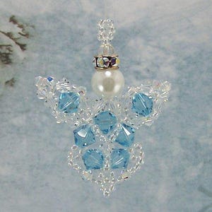 May include: A delicate beaded angel ornament with a pearl centre and blue crystal wings. The ornament is made with clear and light blue beads.