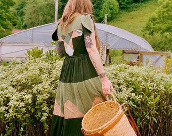Flowy green dress with many pockets, flutter sleeves & handmade quilt details. Soft and stretchy, bamboo jersey. Moss and Lichen.