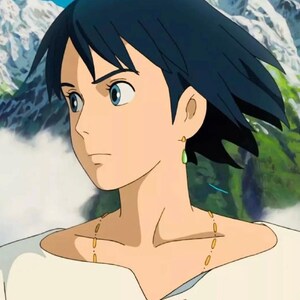 May include: An animated character with dark blue hair and blue eyes, wearing a white shirt and a gold necklace. The character has a green teardrop-shaped earring. The background shows a mountain landscape.