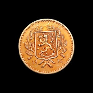 May include: A gold-colored coin with a detailed design. The coin features a coat of arms with a lion, surrounded by wheat stalks and the numbers "19" and "32". The coin has a textured edge and is set against a black background.