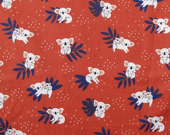 May include: Red fabric with a repeating pattern of white koalas holding smaller koalas. The koalas are surrounded by dark blue leaves and white dots.