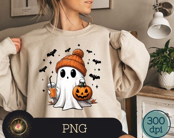 May include: Beige sweatshirt featuring a cute cartoon ghost wearing an orange beanie and holding a pumpkin and a drink. Black bats and stars surround the ghost, creating a Halloween theme. The image has a PNG file format.