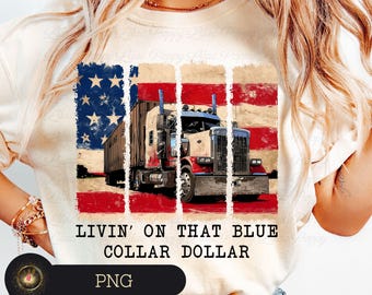 May include: Cream-colored t-shirt featuring a graphic of a semi-truck set against a distressed American flag design. The text "LIVIN' ON THAT BLUE COLLAR DOLLAR" is printed below the image. The design incorporates red, white, and blue colors.