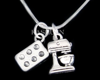 May include: Silver necklace with two charms: a miniature stand mixer and a baking pan with six indentations.