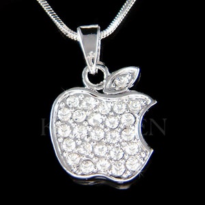 May include: A silver necklace with a crystal-encrusted apple pendant. The apple is a popular symbol of technology and is a great gift for anyone who loves tech.