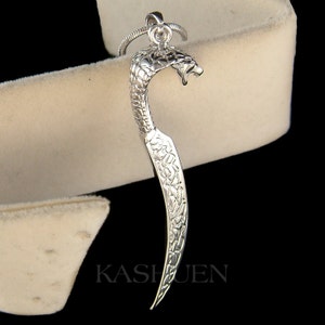 May include: Silver-toned snake pendant necklace with a detailed snake head and body. The snake is curled into a crescent shape.