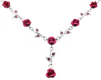 May include: A silver necklace with a pink rose pendant and smaller pink roses along the chain. The roses have rhinestones on the leaves.