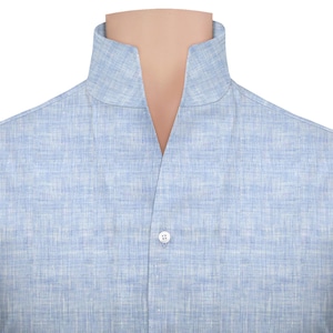 May include: Pale blue linen shirt featuring a mandarin collar and a single button. The fabric has a subtle textured weave. The collar is a stand-up style, offering a classic and versatile look. The shirt is a light, breathable garment.