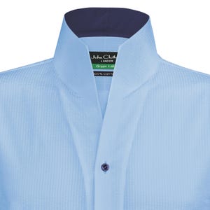 May include: A light blue dress shirt with a mandarin collar and a navy blue inner collar. The shirt has a small label that reads "John Cloth London Green Lab 100% Cotton".