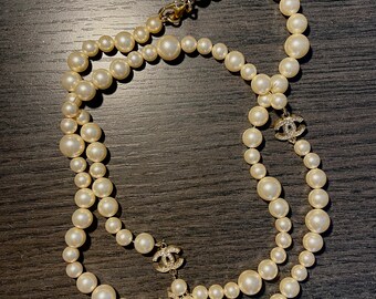 Chanel long pearl necklace with CC logo pendants. 100% authentic, pre-loved, in great condition.