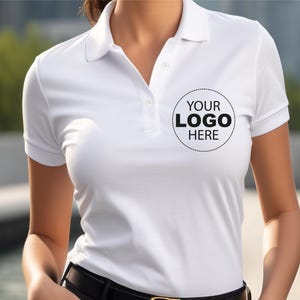 A woman wearing a white polo shirt with a logo on the front.