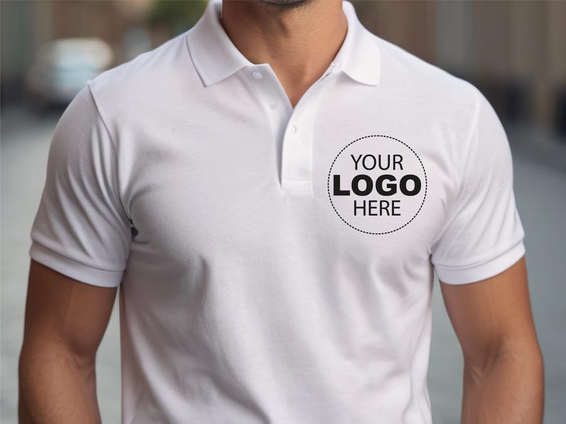 A man wearing a white polo shirt with a logo on the left side of the chest.