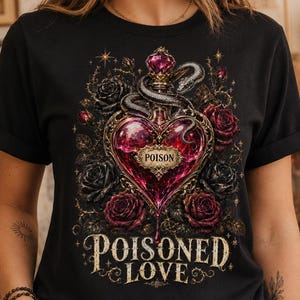 May include: A black t-shirt featuring a graphic of a heart-shaped glass bottle filled with red liquid, labelled POISON. A snake is coiled around the bottle, surrounded by dark red and black roses. The text POISONED LOVE is printed below in gold.