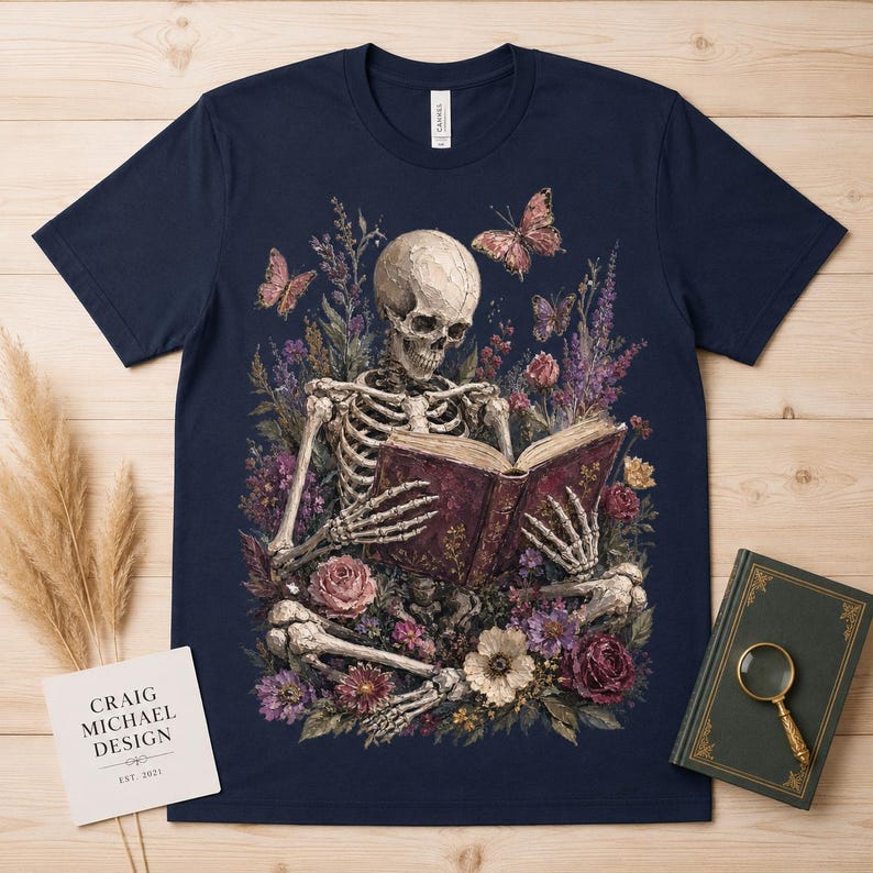 Skeleton reading a book surrounded by flowers and butterflies.