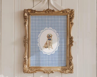 May include: A gold framed picture with a blue and white gingham pattern. A white oval with a lace border contains a watercolour illustration of a golden retriever wearing a blue bow tie.