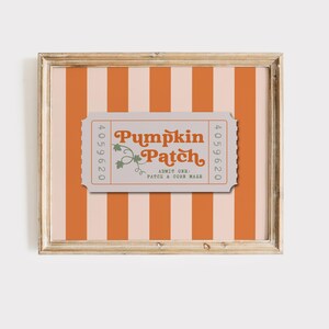 May include: A framed print with a vintage-style design. The background features vertical orange and cream stripes. A ticket-shaped graphic in the center reads "Pumpkin Patch" with a decorative vine and the text "Admit One: Patch & Corn Maze."