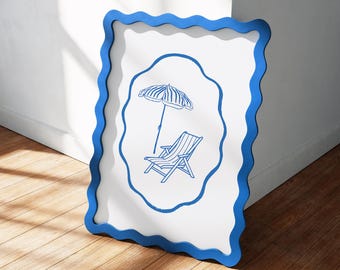 May include: A white framed art piece with a blue wavy border. The artwork features a blue line drawing of a beach umbrella and a lounge chair. The frame is leaning against a white wall and a wooden floor.