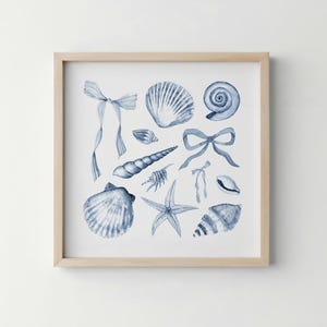 May include: Watercolor print of various seashells, starfish, and bows in shades of blue. The artwork is framed in a light wood frame, creating a coastal or nautical theme. The image includes detailed illustrations of different shell types.