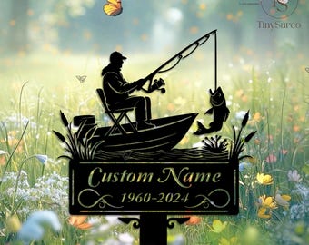 May include: Black metal silhouette of a person fishing from a boat with a fish on the line. The silhouette is mounted on a black metal stake with a sign that reads "Custom Name 1960-2024".