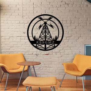 May include: Black metal wall art featuring a stylized radio tower with lightning bolts and the call sign "KB9GMZ" in a circle.