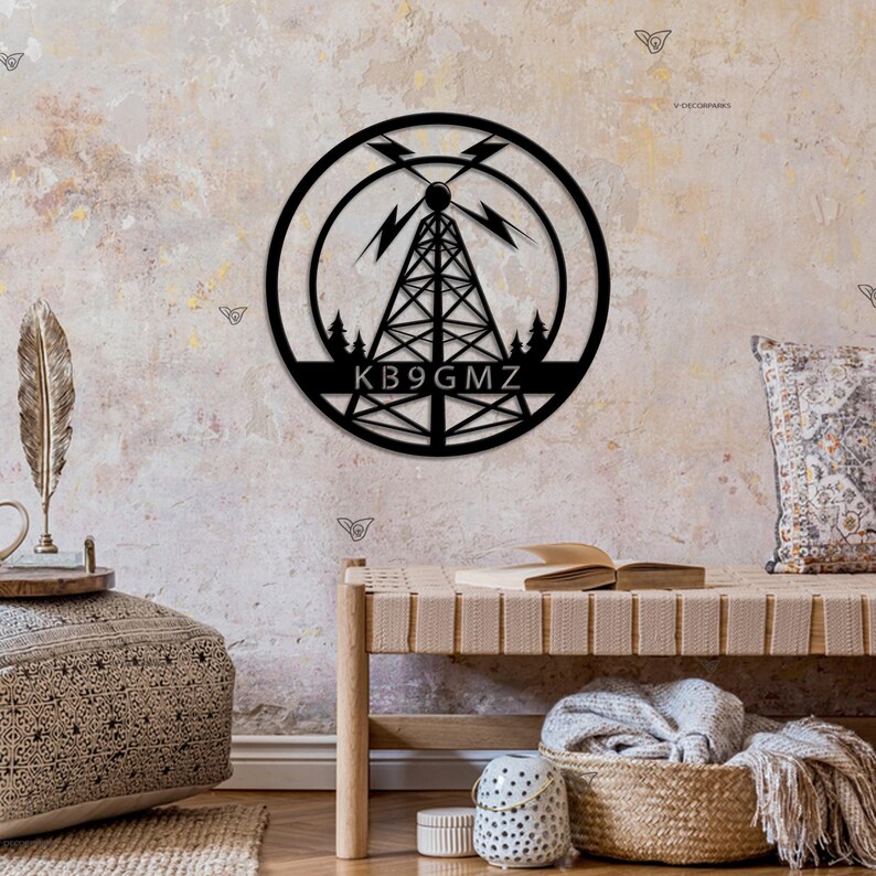May include: Black metal wall art featuring a stylized radio tower with lightning bolts and trees. The call sign "KB9GMZ" is displayed below the tower.