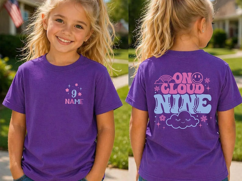 May include: A purple t-shirt with the text "9" and "NAME" with star graphics. The back of the shirt has the words "ON CLOUD NINE" with a rainbow, smiley face, cloud, and star graphics. The shirt is worn by a young person.