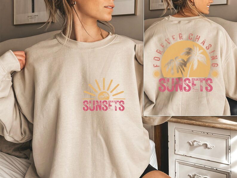 May include: A beige sweatshirt with a graphic print of a sun and palm trees. The text "Forever Chasing Sunsets" is printed on the back of the sweatshirt. The text "Sunsets" is printed on the front of the sweatshirt.