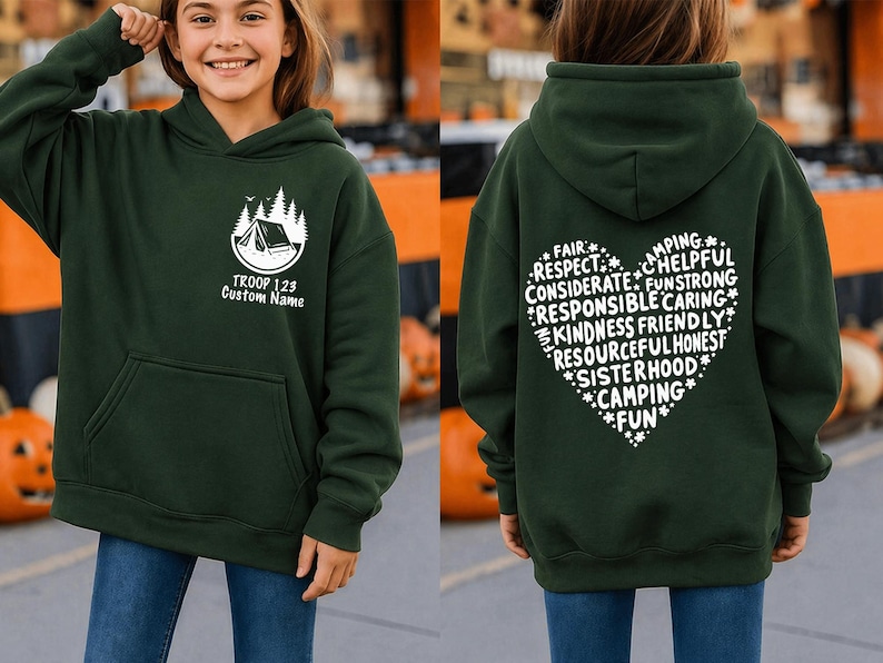 May include: Dark green hooded sweatshirt with a front pocket and a white graphic of a tent and trees. The text "TROOP 128 Custom Name" is below the graphic. The back of the sweatshirt has a heart-shaped design with words like "Camping" and "Fun".