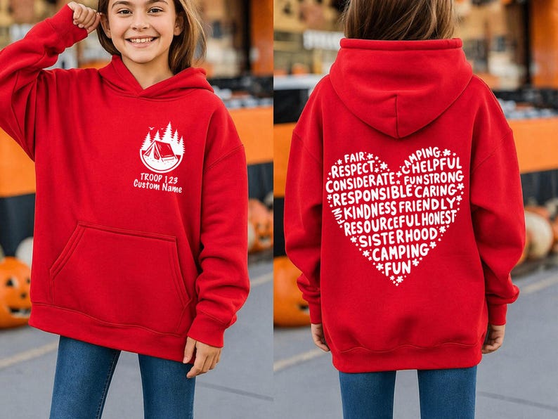 May include: Red hooded sweatshirt with a front pocket and white graphic. The front graphic includes a tent and trees with the text "TROOP 123 Custom Name". The back features a heart-shaped design with words like "Camping" and "Fun".