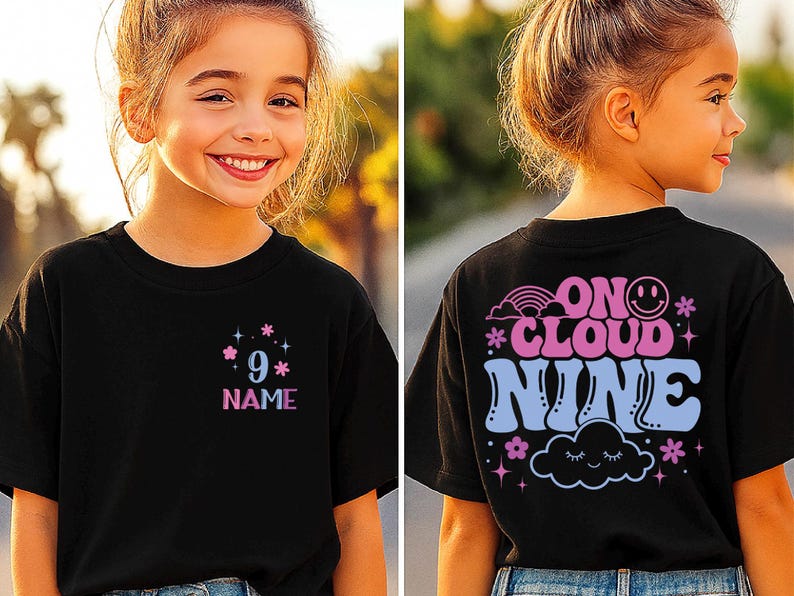 May include: Black t-shirt with a colorful design. The front features the number 9 and the word "NAME" in a pink and blue font. The back of the shirt says "ON CLOUD NINE" with a rainbow, smiley face, cloud, and flowers.