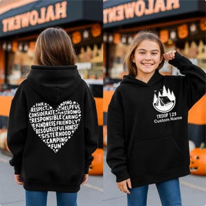May include: Black hooded sweatshirt with a white heart-shaped graphic on the back, featuring words like "Respect" and "Camping." The front displays a camping scene with the text "TROOP 123 Custom Name."
