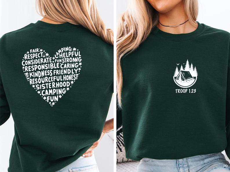 May include: Dark green sweatshirt with a white heart-shaped graphic on the back, filled with words like "respect" and "kindness." The front features a camping-themed logo with the text "TROOP 123."