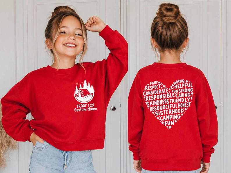 May include: Red sweatshirt with a white camping graphic and text "TROOP 123 Custom Name" on the front. The back features a heart-shaped design with words like "FAIR", "RESPECT", and "CAMPING".