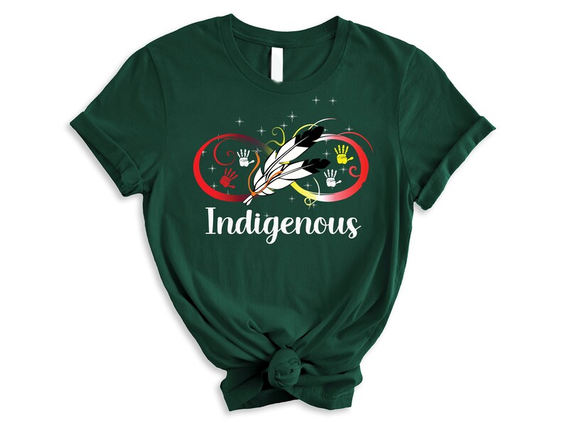 May include: A dark green t-shirt with an infinity symbol design featuring a feather and handprints in red, yellow, orange, and white. The text "Indigenous" is printed below the symbol.