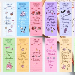 May include: A collection of colorful library card-style bookmarks with various themed illustrations and text. Designs include a crown, ice skates, a castle, and phrases like "Hot Girls Read Romance" and "Booked in a Sci-Fi Universe."