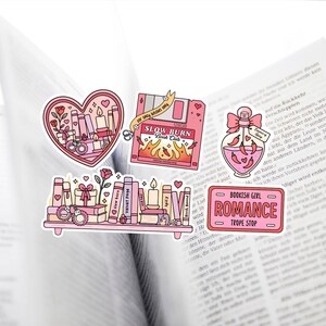 May include: A collection of pink and red stickers with a bookish theme. Designs include a heart with books and candles, a floppy disk with flames, a potion bottle with chili peppers, and a shelf of books. The text includes "Slow Burn Book Club" and "Bookish Girl Romance".