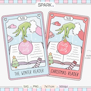 May include: Two tarot card designs with a winter theme. One card is light blue and the other is pink. Each card features a green hand reaching for a pink ornament that says "Holly Jolly". The text on the cards reads "The Winter Reader" and "Christmas Reader".