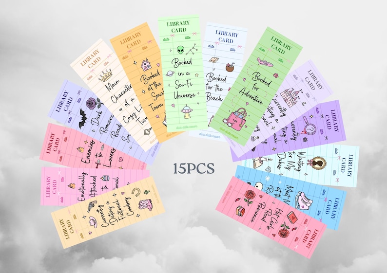 May include: Fifteen colorful library card-themed bookmarks with various designs and text. Each bookmark features a different color and design, including illustrations of a crown, a house, an alien, a beach bag, and a castle. Text includes "Main Character", "Booked in a Sci-Fi Universe", and "Booked for Adventure".