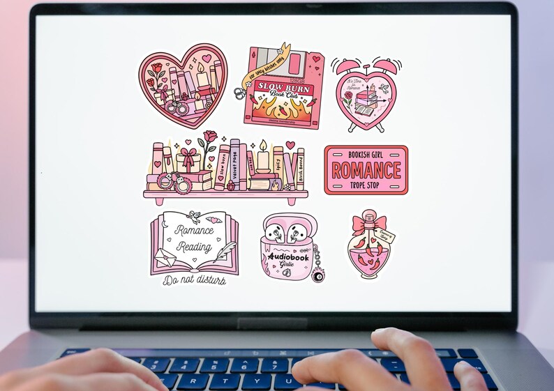 May include: A laptop screen displays a collection of pink and white stickers with a romance theme. The stickers feature hearts, books, candles, and the text "Romance Reading" and "Audiobook Girls".