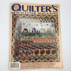 May include: A vintage issue of Quilter's Newsletter Magazine from October 1995. The cover features a colorful quilt design with houses, trees, and birds. The magazine's title is in large, bold letters, and the cover also includes article titles.