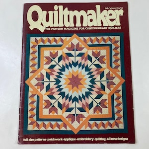 May include: A vintage issue of "Quiltmaker" magazine. The cover features a colorful quilt design with a starburst pattern in shades of orange, teal, and burgundy. The magazine title is in large, cream-colored letters. Text at the bottom lists quilting techniques.