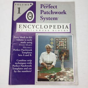 May include: The cover of "The Perfect Patchwork System Encyclopedia of Patchwork Blocks, Volume 1" features a woman and examples of quilt blocks. The cover is purple and grey with text that reads "Every block in this volume is easily made using From Marti Michell Perfect Patchwork Templates Sets A and B."