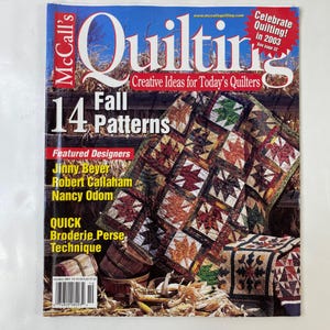 May include: A magazine cover for McCall's Quilting, featuring a quilt with fall leaf patterns. The cover includes text such as "14 Fall Patterns" and "Creative Ideas for Today's Quilters." Featured designers are listed.