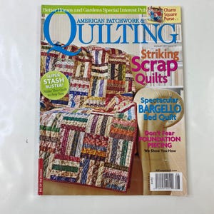 May include: The August 2011 issue of American Patchwork & Quilting magazine. The cover shows a colourful quilt draped over a chair. Text includes "Striking Scrap Quilts" and "Spectacular Bargello Bed Quilt".