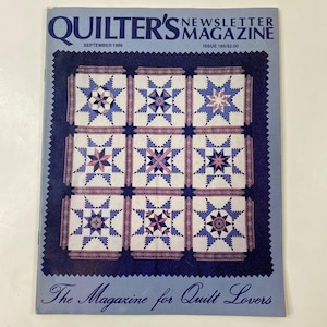 May include: A vintage copy of Quilter's Newsletter Magazine, September 1986 issue. The cover shows a quilt design with nine star patterns in blue, pink, and white. The magazine title and issue details are at the top, with the tagline "The Magazine for Quilt Lovers" at the bottom.