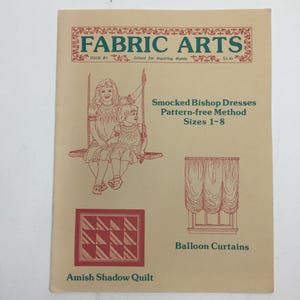 May include: A vintage Fabric Arts magazine cover with illustrations and text. The cover features drawings of two children on a swing, balloon curtains, and an Amish shadow quilt. Text includes "Smocked Bishop Dresses" and "Sizes 1-8".