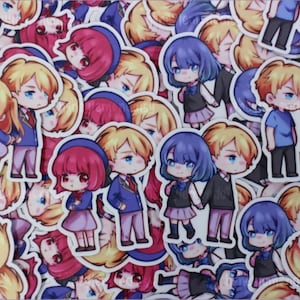 May include: A collection of colorful anime character stickers featuring various characters with different hair colors and outfits. The stickers are printed on white paper and have a glossy finish.
